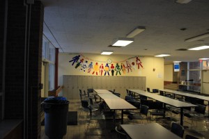 A mural listing the ten IB learner attributes overlooks the middle school cafeteria.