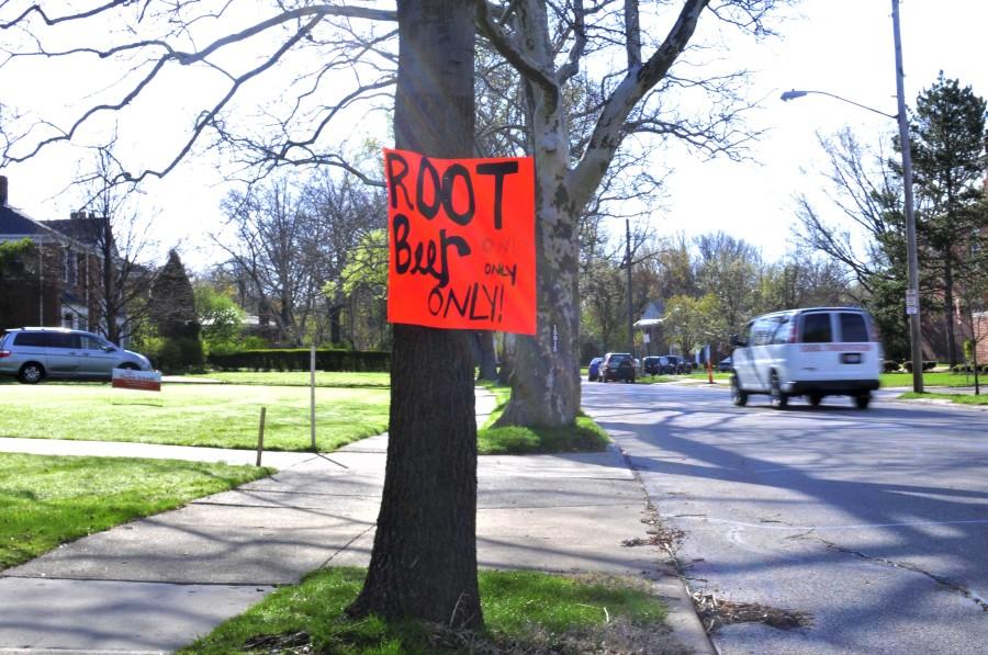 A sign titled “Root beer only, only” tells bystanders and the high school that the senior prank, representing a college fraternity party does not feature alcohol May 5, 2014. The prank was set up in a vacant lot across from the North Gym parking lot. The lot is owned by Shaker parents.