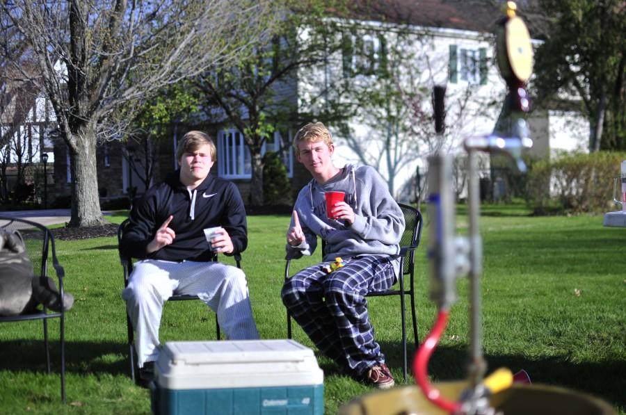 Seniors Jacob Herbst and Nick Adamson pose for a picture next to a keg filled with root beer May 5, 2014.