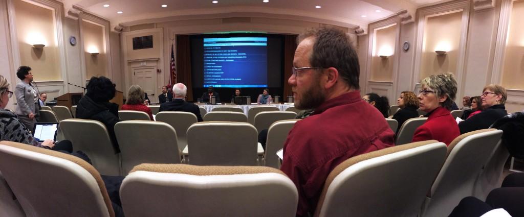 Teachers and community members listen as a Shaker parent makes a comment to the board at its Dec. 17 meeting.