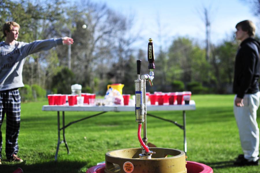 Seniors Jacob Herbst and Nick Adamson play “root beer pong” during their senior prank at an Onaway Road property during first period May 5, 2014.